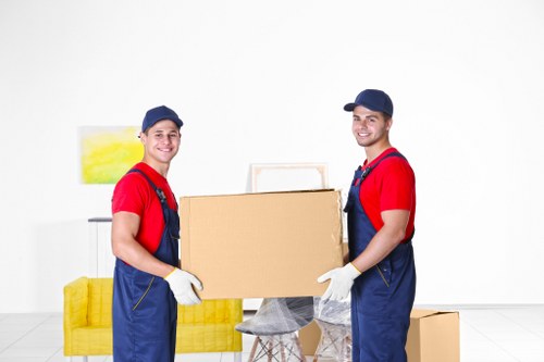 Professional movers carefully handling furniture during a move in Kentish Town