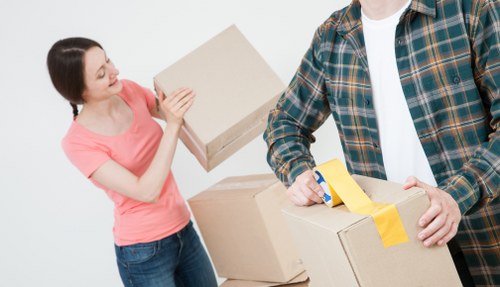 Professional movers coordinating equipment during a commercial move