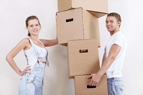 Professional movers handling office equipment with care