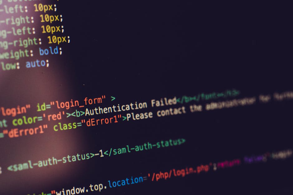 A close-up photograph of a computer screen displaying a web page with a login form showing an 'Authentication Failed' message in red text, surrounded by lines of code highlighted in various colors suc